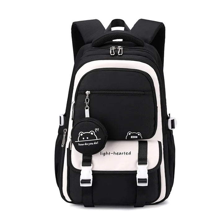 Front view of the same backpack in black and cream, with the black bear charm pouch and white buckles on the flap. 11