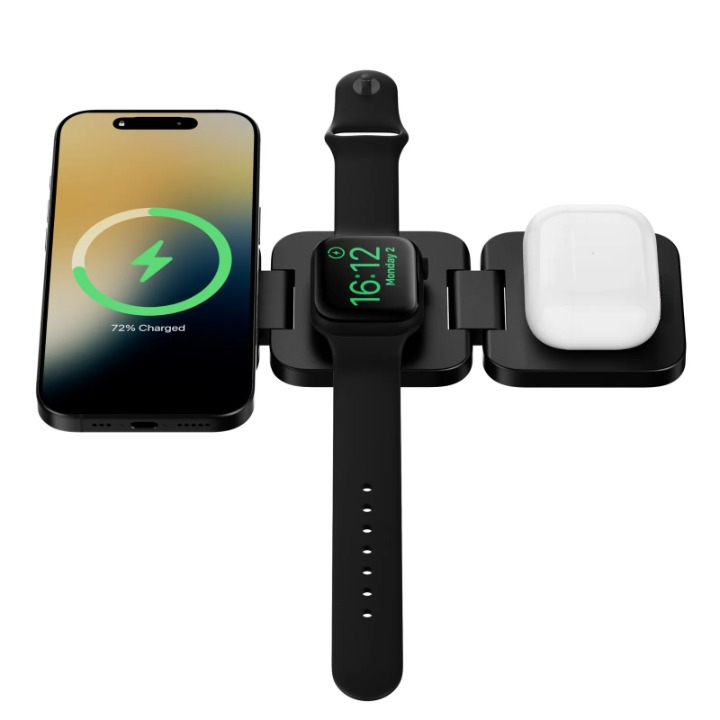 Black foldable magnetic wireless charging station laid flat from above with a phone, smartwatch and earbuds case charging.