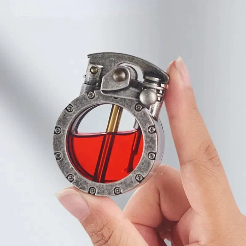 Hand holding the silver vintage-style lighter, showing the transparent tank and brass wick tube.