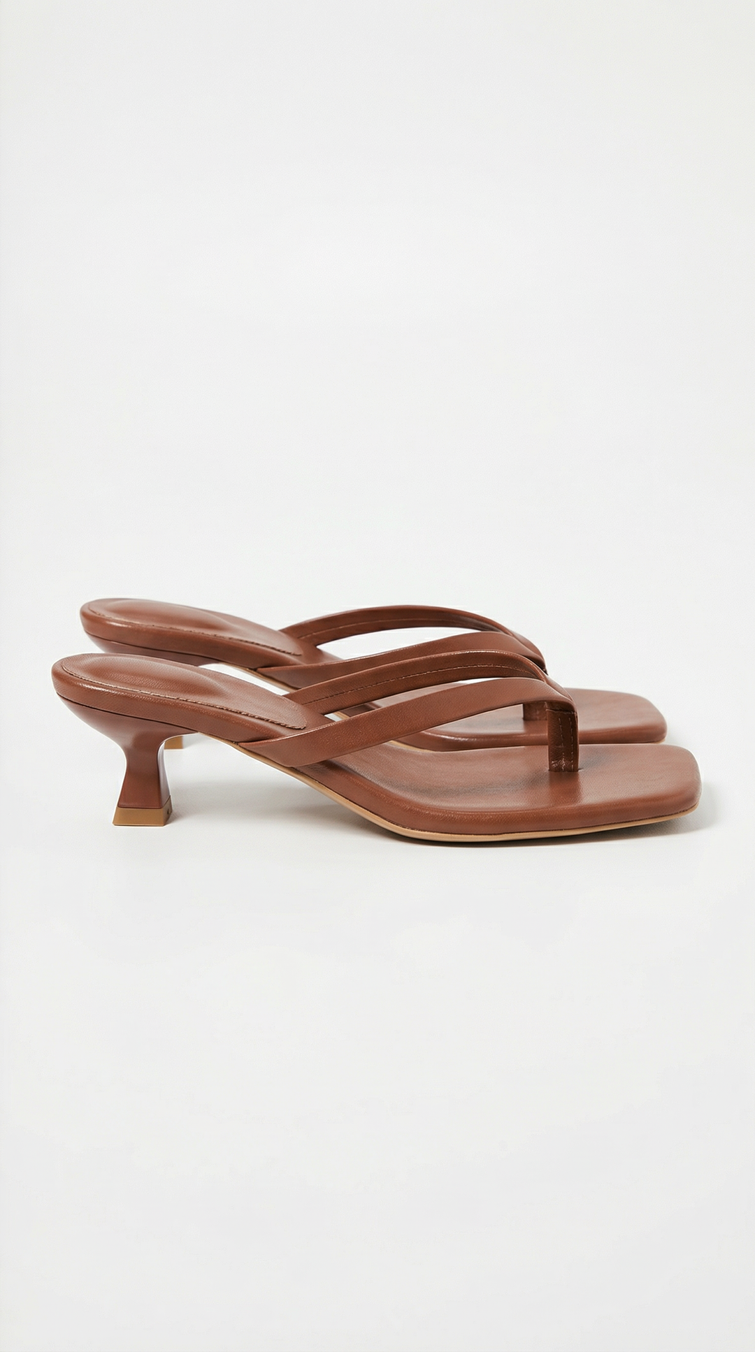 Pair of brown square-toe thong sandals with a low flared kitten heel and padded footbed