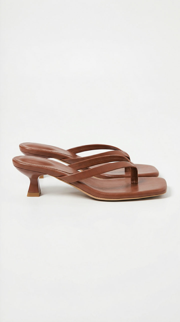 Pair of brown square-toe thong sandals with a low flared kitten heel and padded footbed