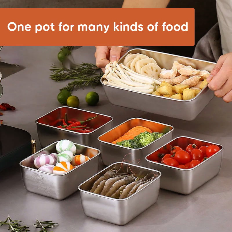 Several steel containers holding shrimp, tomatoes, broccoli, candies and mushrooms on a kitchen counter, with a hand lifting 3