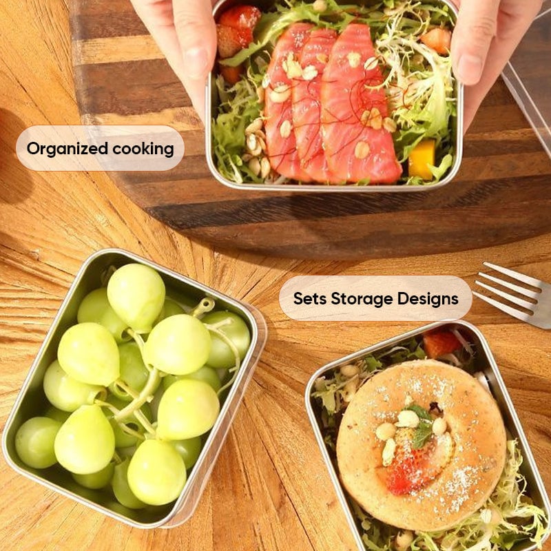 Overhead view of three containers on a wooden table holding salmon salad, grapes, and a pastry on greens 8