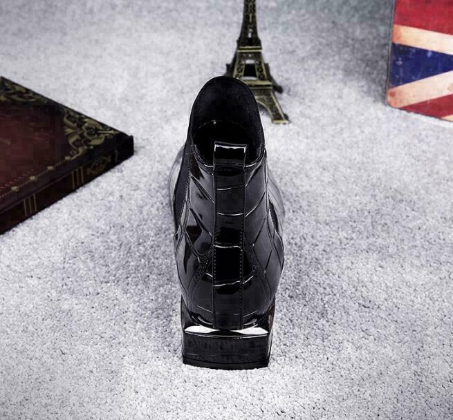 Straight-on back view of the black croc-textured boot, showing the heel and pull loop 4