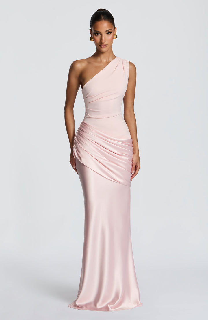 Dress in soft blush pink with a draped satin hip and gold ball earrings, shown straight from the front. 26