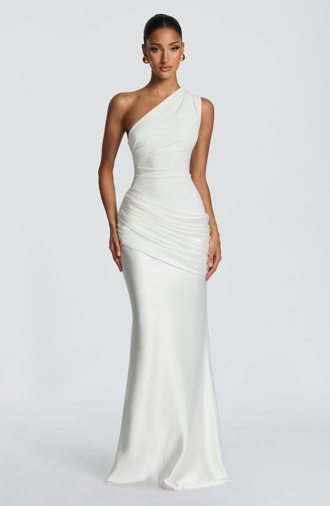 Front view of the white one-shoulder maxi with a fitted bodice, gathered satin hip and flowing floor-length skirt. 28