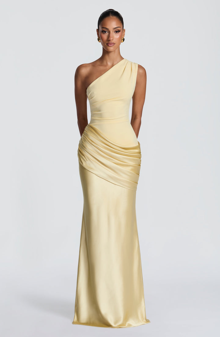 Pale yellow version of the one-shoulder maxi dress, full-length front view with a ruched satin drape across the hips. 45