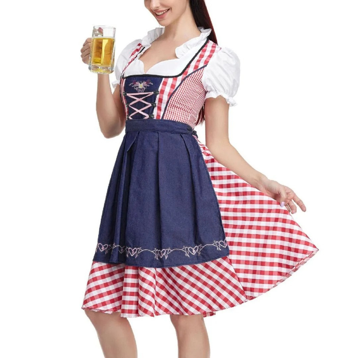 Red gingham dirndl with navy denim-look apron, front view at an angle.