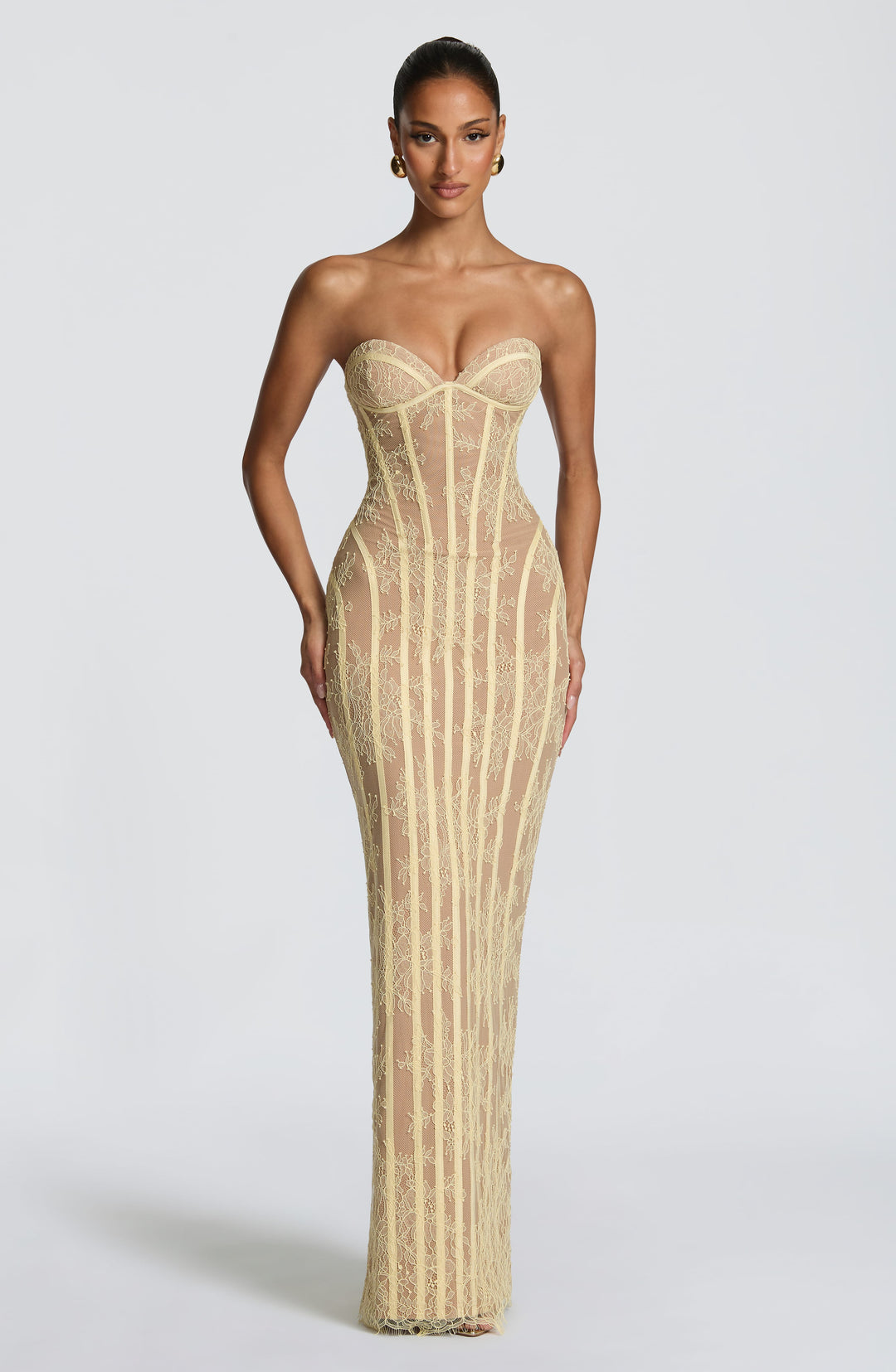 Front view of the soft yellow strapless lace maxi dress with sweetheart bustier and corset boning over a nude lining.