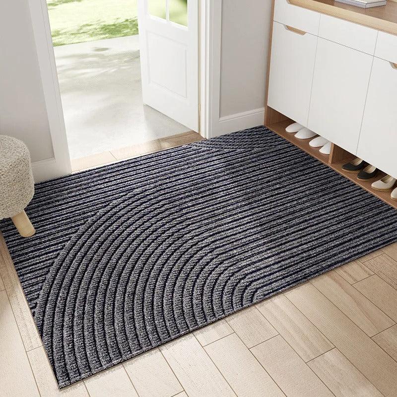Gray doormat with curved concentric ridges, another view.