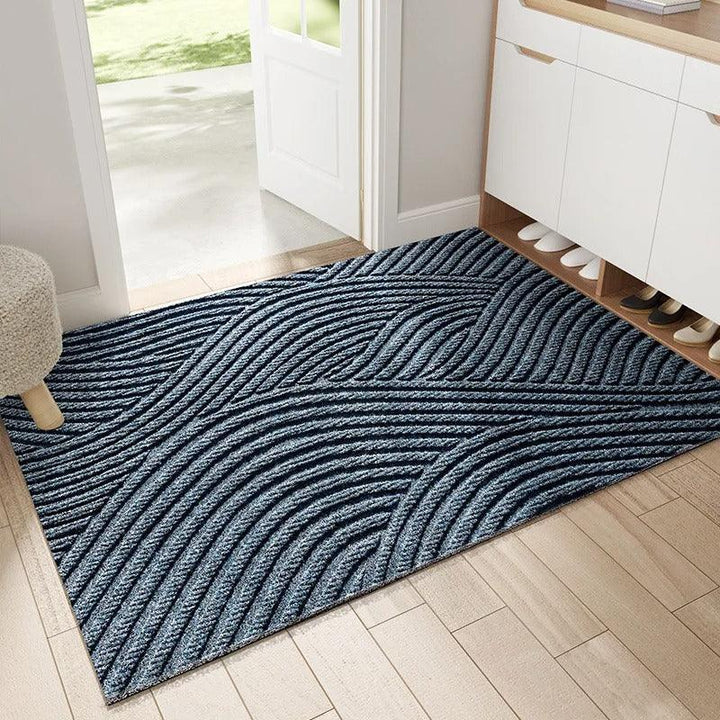 Blue doormat with flowing wave-like ridges, another view.