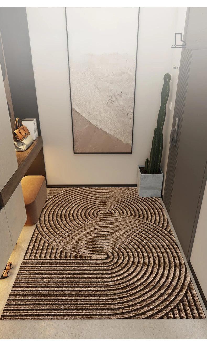 Brown doormat with large swirling concentric arcs, another view.