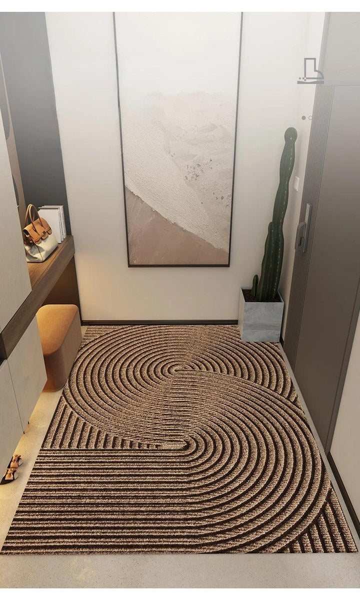 Brown doormat with large swirling concentric arcs, another view.