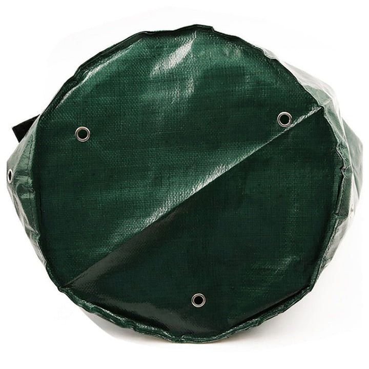 Detail of the bottom of the green grow bag with three metal drainage eyelets.