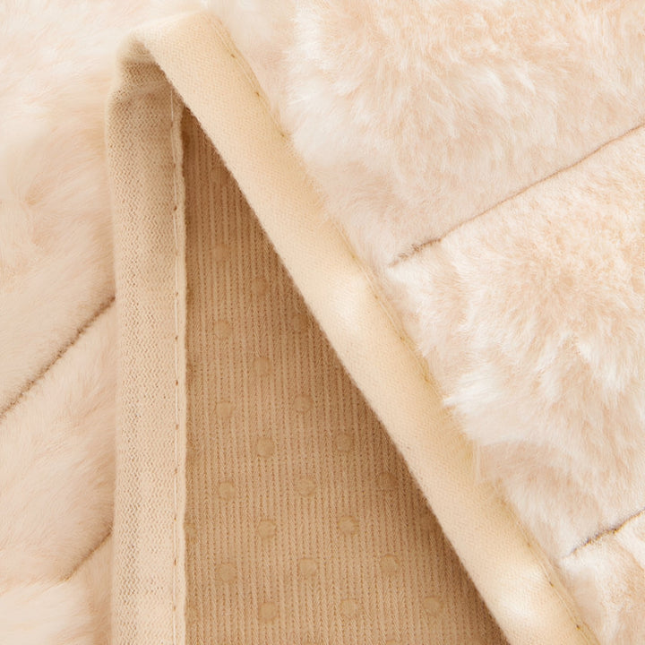 Plush non-slip couch cover for dogs and pets, detail of the beige backing with grip dots