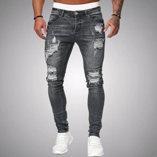 Men's slim-fit distressed jeans in faded gray wash, front view, detail.