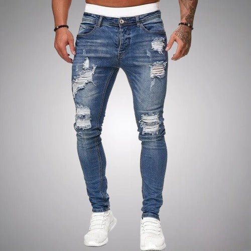 Men's slim-fit distressed jeans in medium blue wash, front view, detail.