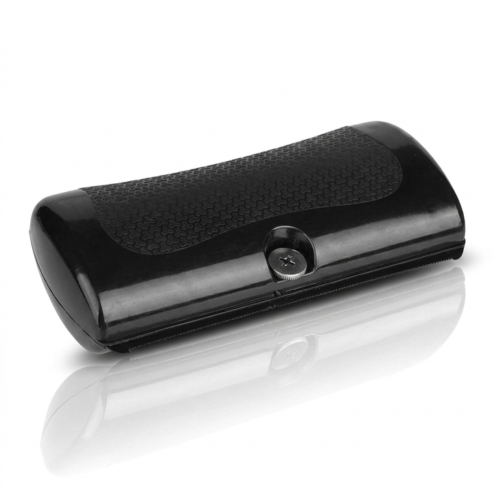 GlowBrush black grooming comb with a textured rubber grip and metal screw on a white background.