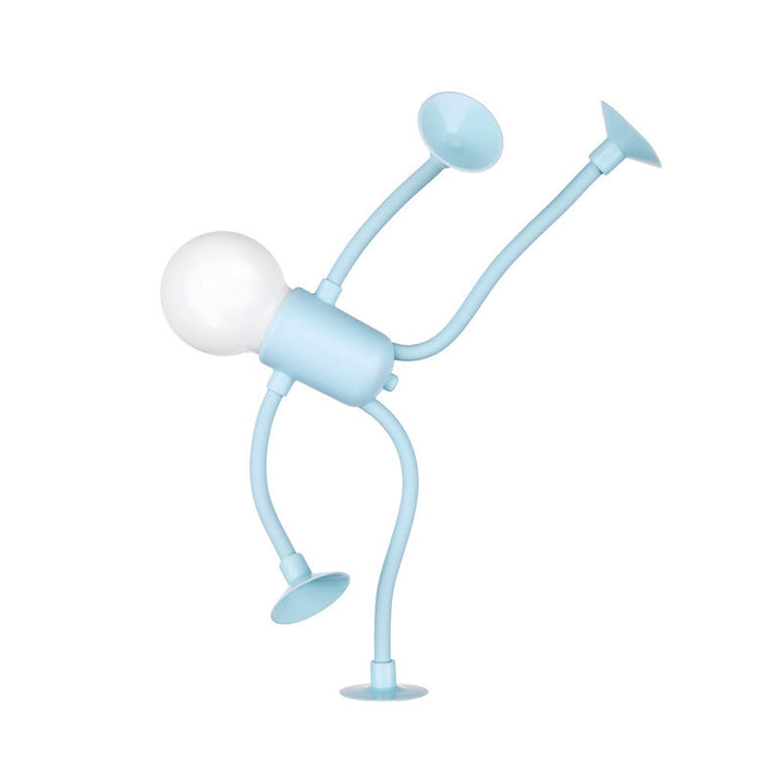 Light blue figure lamp bent into a handstand pose with suction cups on its raised limbs.