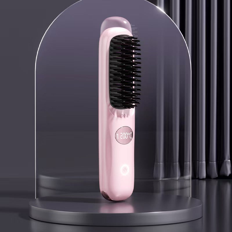 Pink version of the heated brush with round display and touch power button, standing under a glass dome on a dark platform.