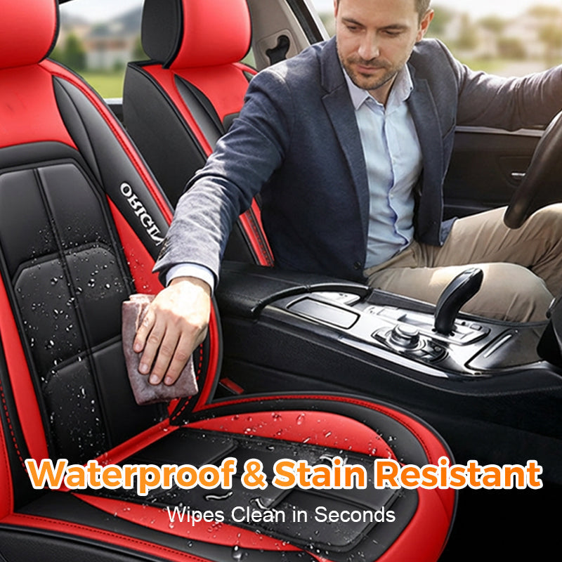 Red and black seat cover being wiped clean, detail.