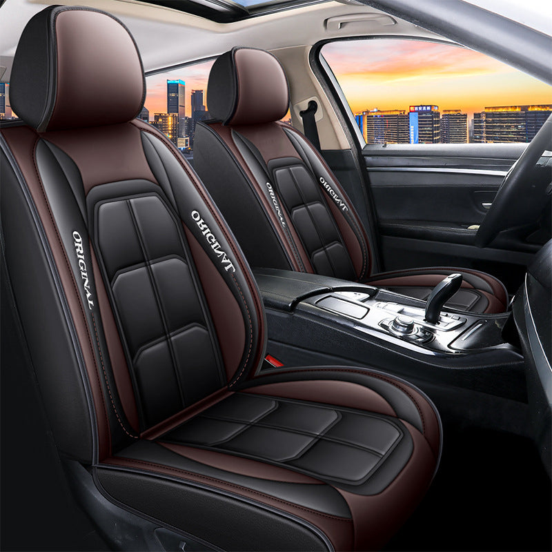 Pair of black front seat covers with brown headrests and brown side panels in a car.