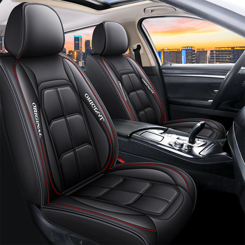 Pair of black and red front seat covers installed in a car interior.