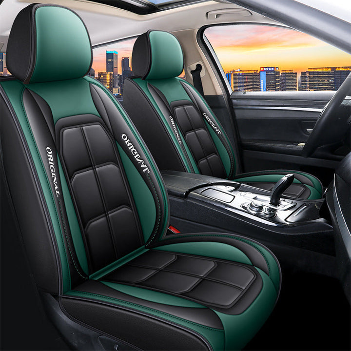 Pair of black front seat covers with green headrests and green side panels in a car.