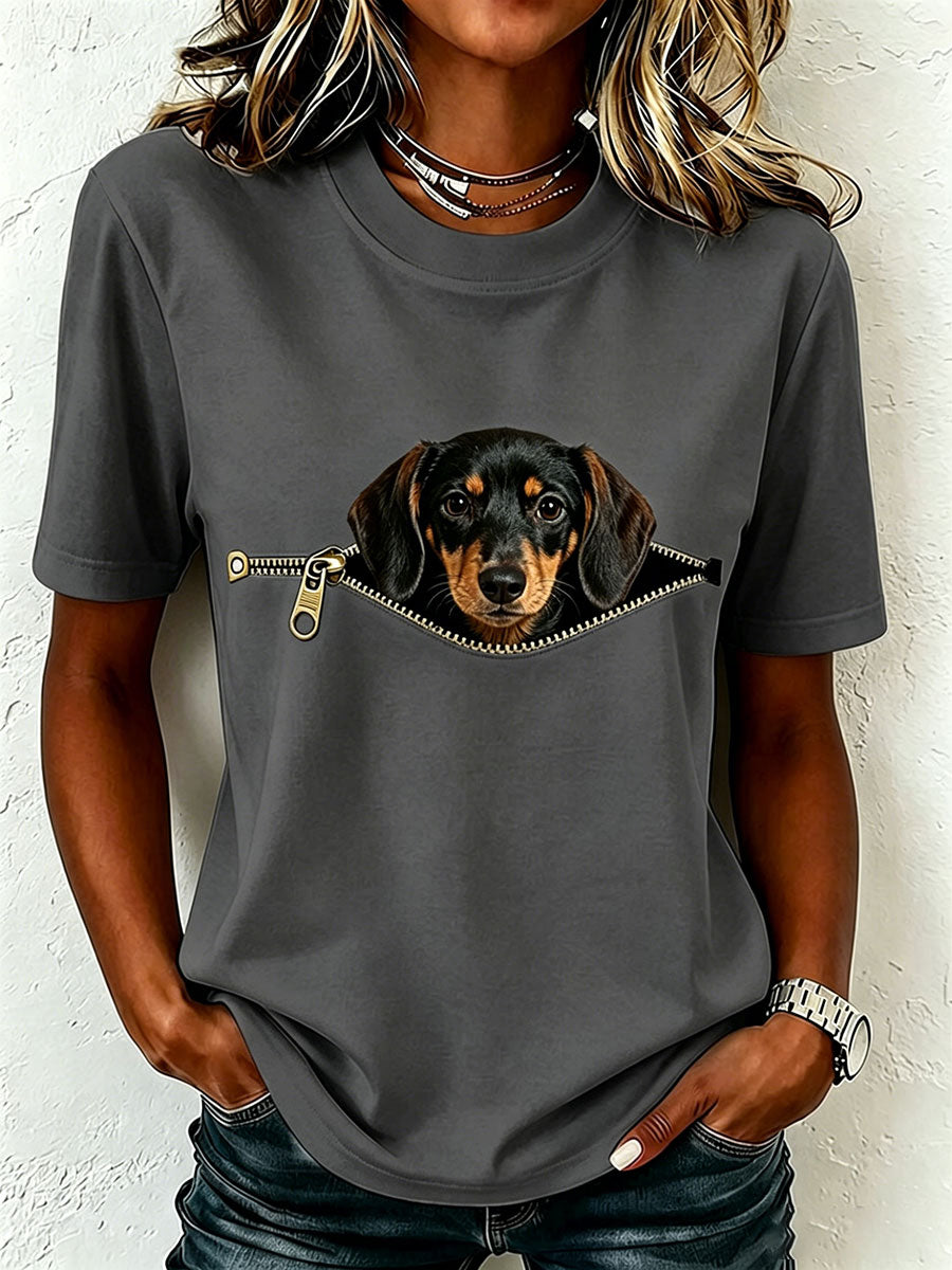 Same crew-neck tee in charcoal gray on a model, showing the dachshund peeking from a printed zipper opening.