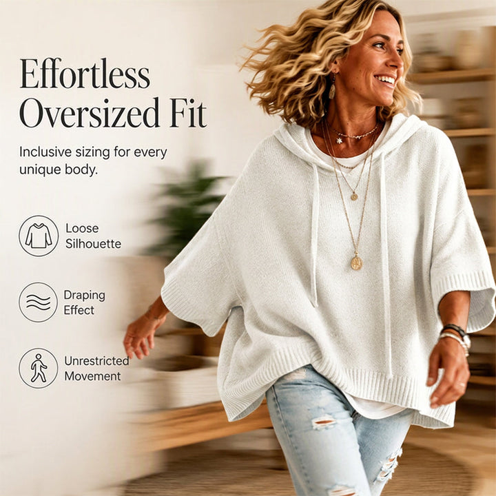 Women's white oversized hooded knit sweater with wide short sleeves, layered necklaces and ripped jeans.