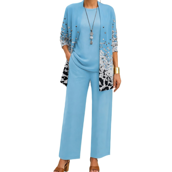 Light blue version of the set, the cardigan in a silver-speckled gradient print over a matching top and pants.