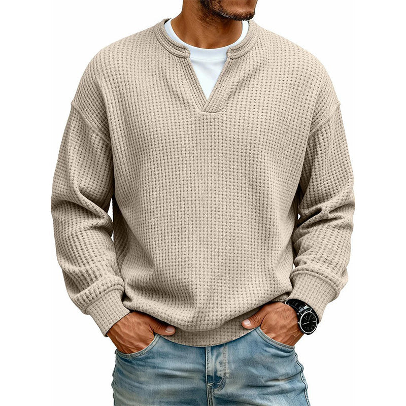 Front view of the top in beige, worn over a white tee with light blue jeans 11