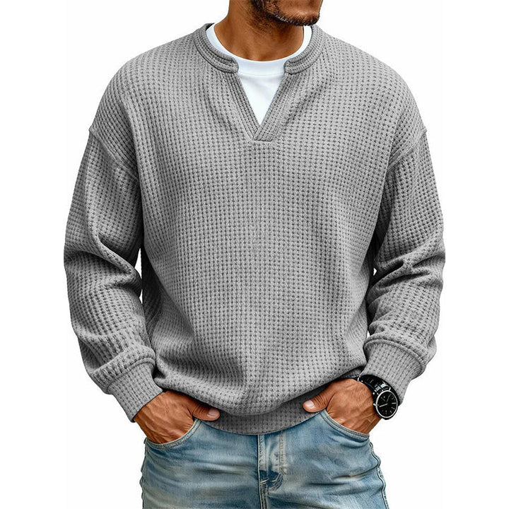Front view of the top in medium gray waffle knit, worn with a watch and jeans 17