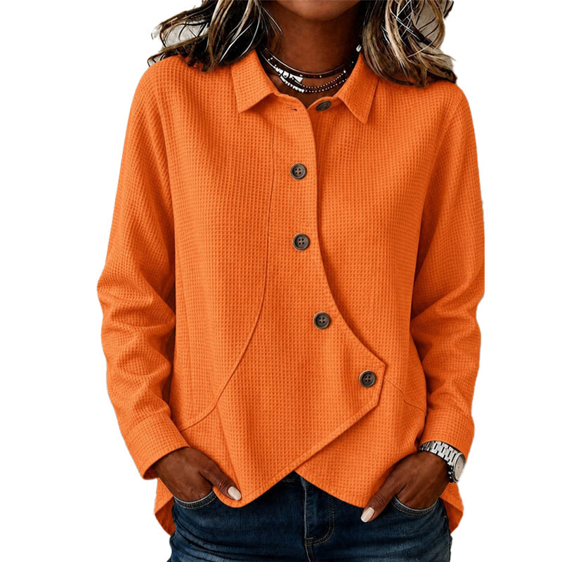 Women's waffle-knit top in bright orange with brown buttons and an asymmetric hem, another view.