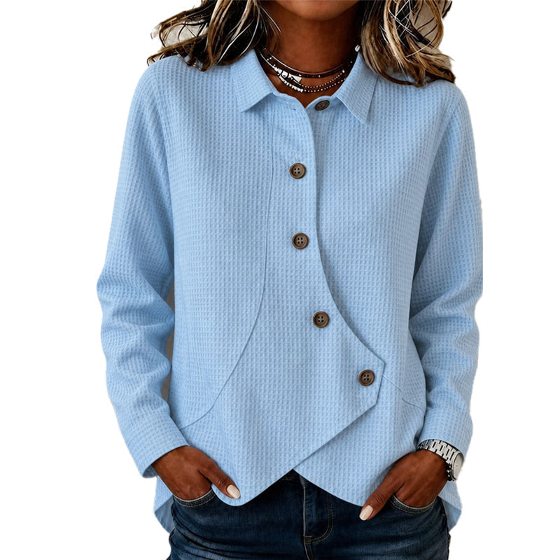 Light blue waffle-knit long-sleeve top with collar, brown buttons and curved asymmetrical hem
