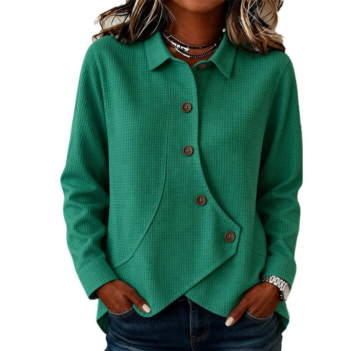 Green waffle-knit long-sleeve top with collar, brown buttons and curved asymmetrical hem