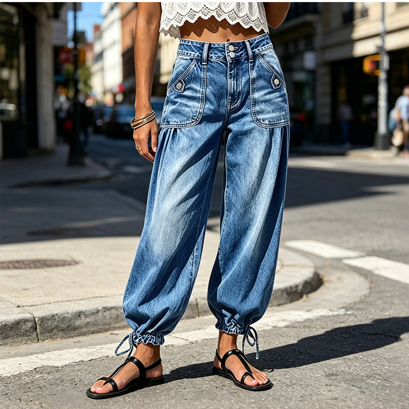 Women's blue barrel jeans with flap pockets and drawstring ankle hems.