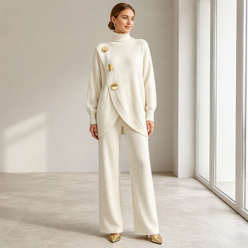 Full-length view of the cream set on a smiling model with hands at her sides, showing the crossover hem and gold buttons. 7