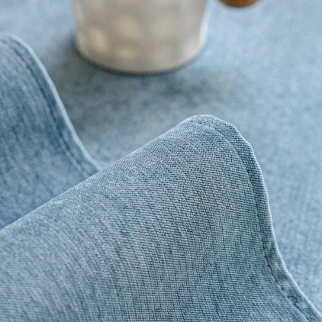Grey anti-slip protective sofa cover detail with light blue woven fabric corner