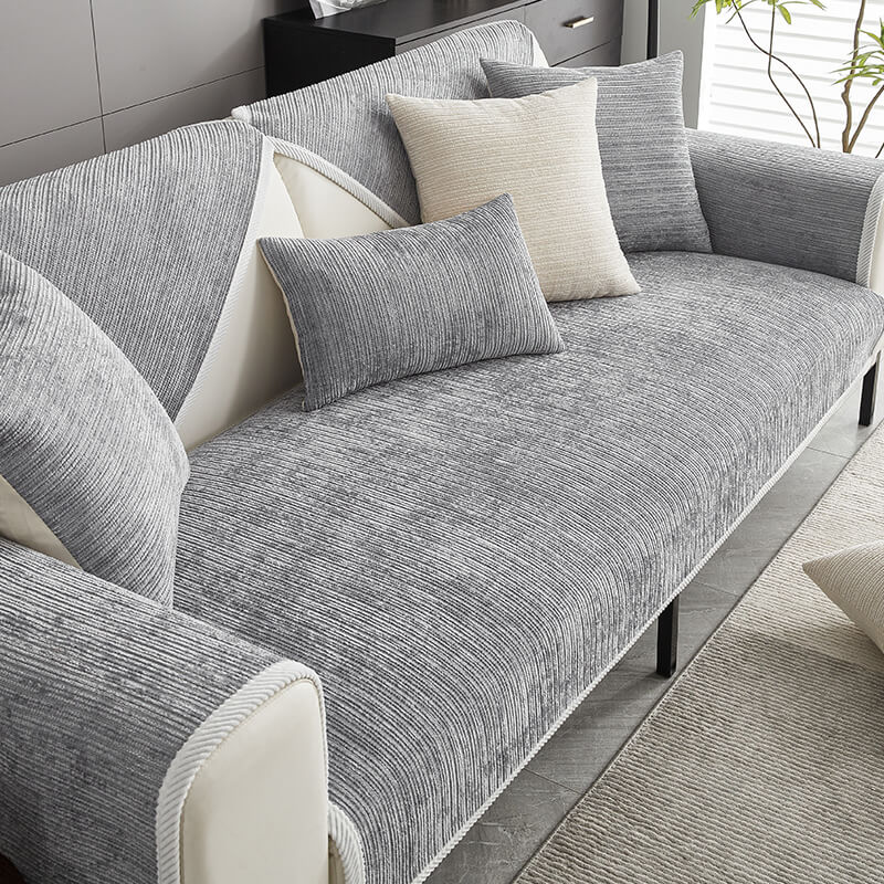 Gray ribbed chenille cover on a sofa seat, backrest and armrests, styled with gray and cream throw pillows. 1