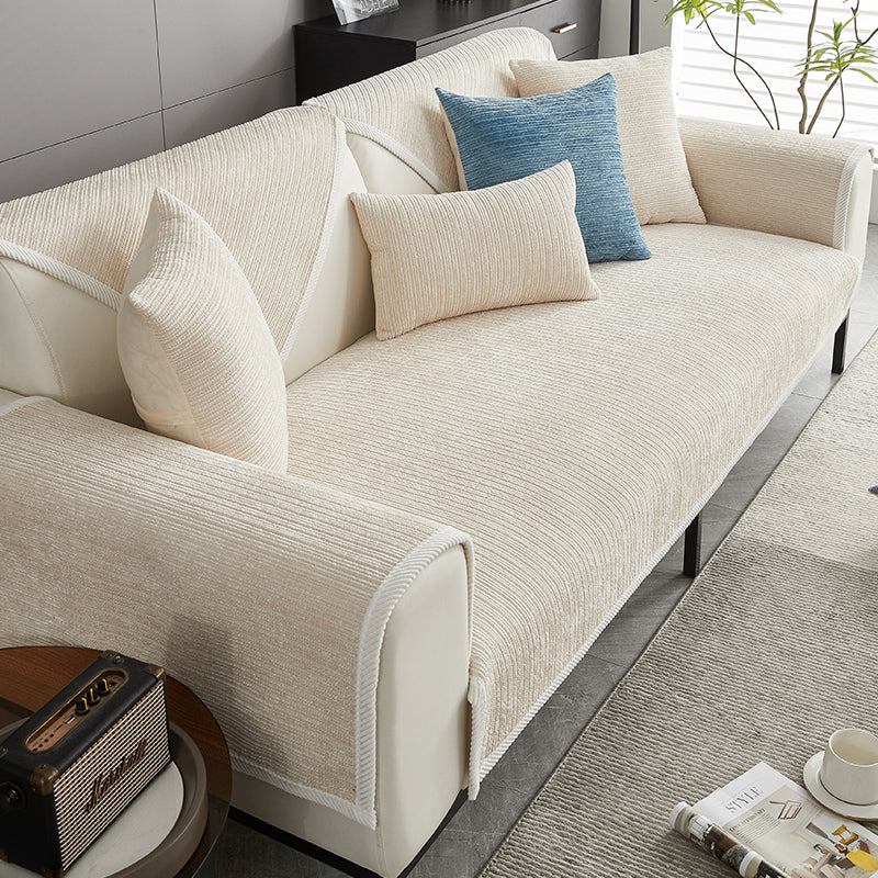 Cream ribbed chenille cover on a sofa, styled with a blue accent pillow and cream cushions. 3