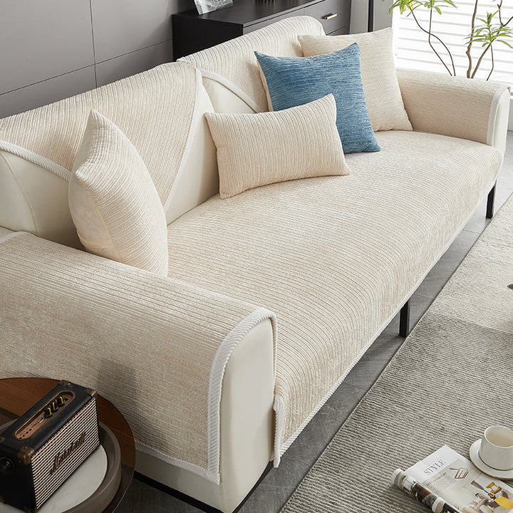 Cream ribbed chenille cover on a sofa, styled with a blue accent pillow and cream cushions. 3