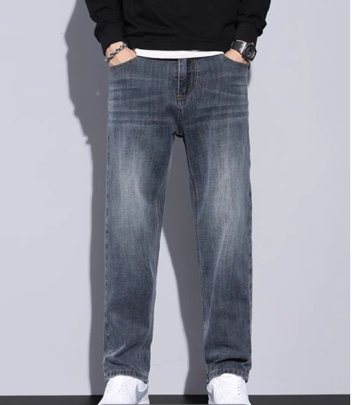 Torso-down view of blue-gray jeans with light fading on a model in a black sweatshirt 11