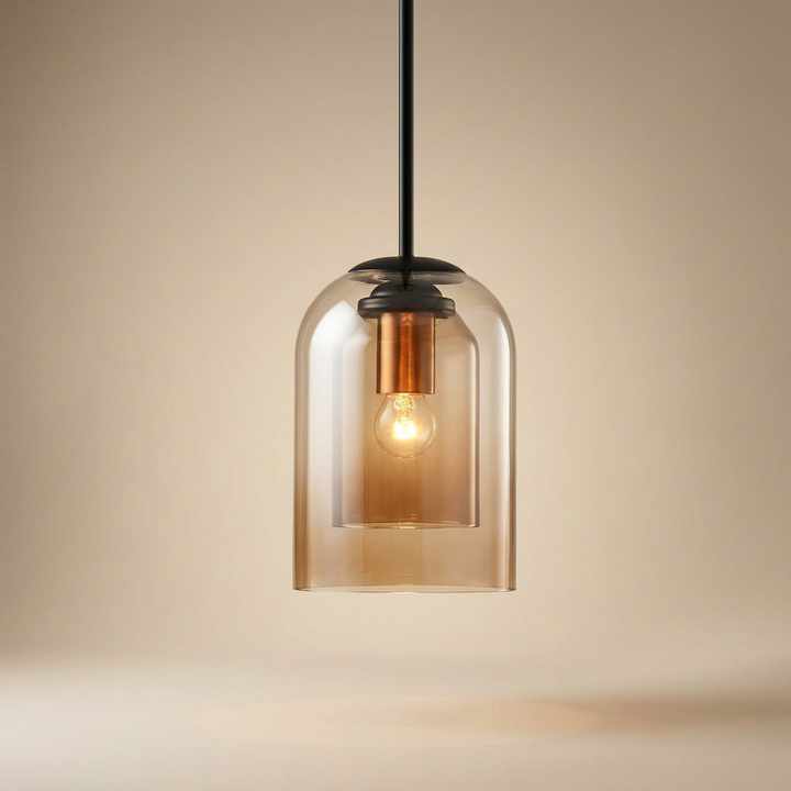Amber layered glass pendant with black rod and copper-toned socket glowing against a warm beige backdrop 14