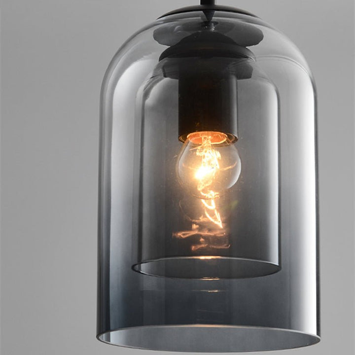 Close-up of the smoke gray double glass shade with a glowing bulb and black socket 7