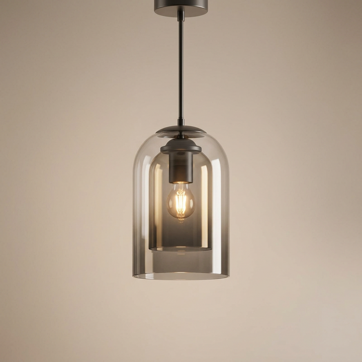 Smoke gray layered glass pendant with dark metal fittings and a lit bulb against a beige backdrop 13