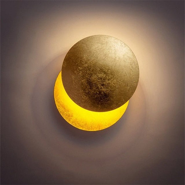 Close view of the gold disc lamp lit, with a bright yellow crescent glowing below 5