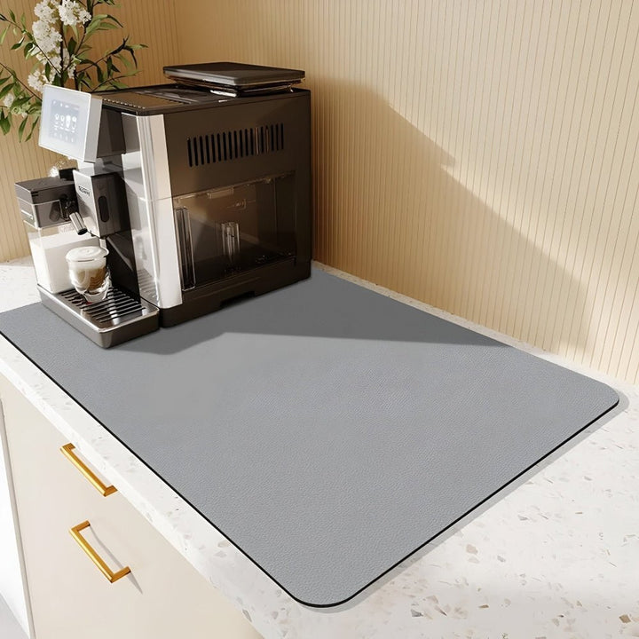 Light gray mat on a speckled terrazzo counter under a coffee machine, beside a striped wall 8