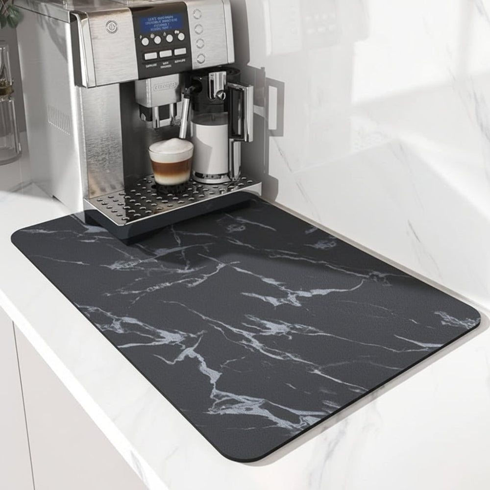 Black mat with white marble veining under a coffee machine, shown from the control panel side 4