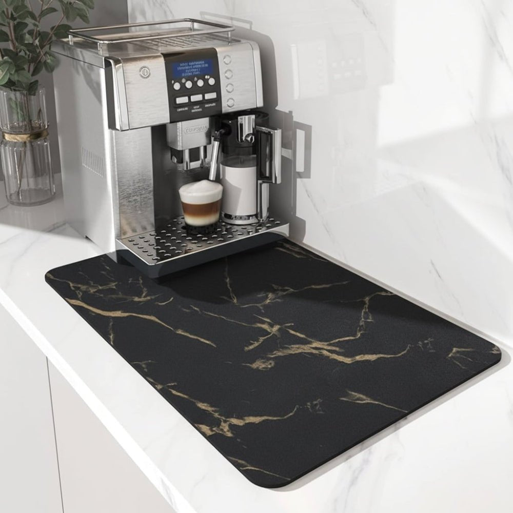Black mat with gold marble veining on a white counter beneath a silver coffee machine 5